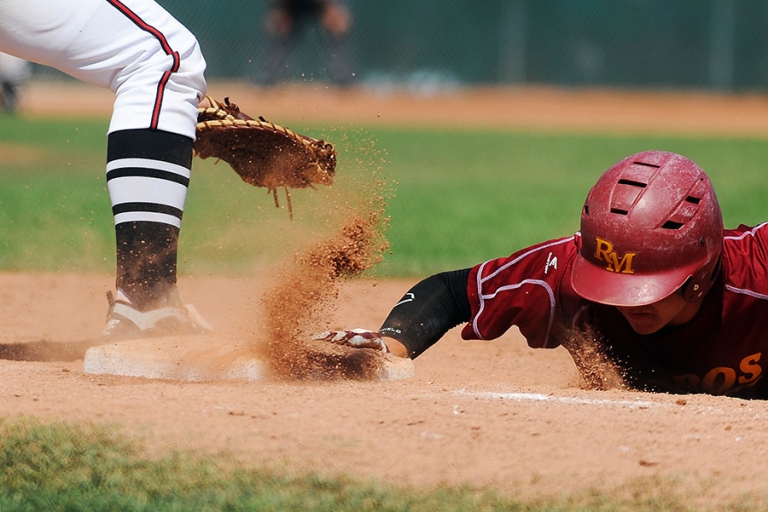 Sliding in to first base during a baseball game in Boulder, Colorado.