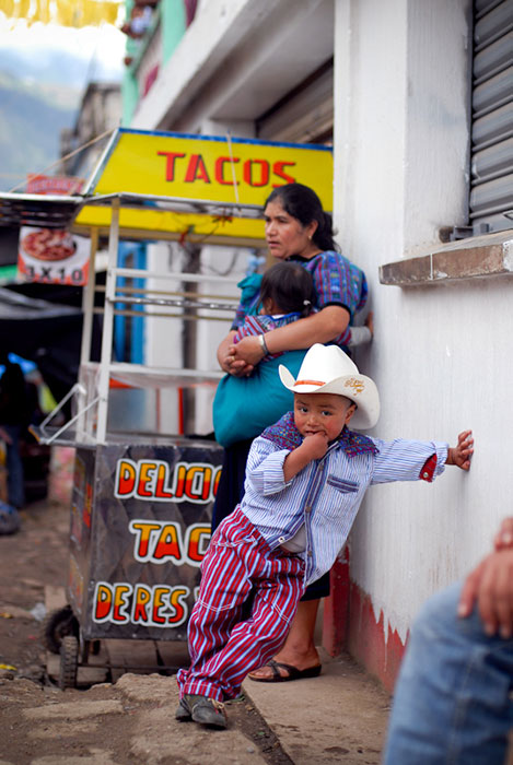 Boy by a taco stand in Todos Santos Guatemala during the Horse Races.