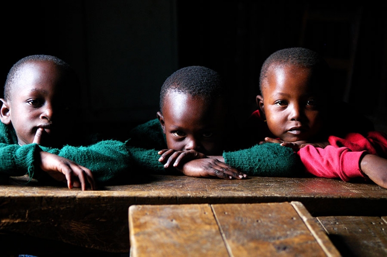 School children in a dark classroom in the slums of Nairobi Kenya.