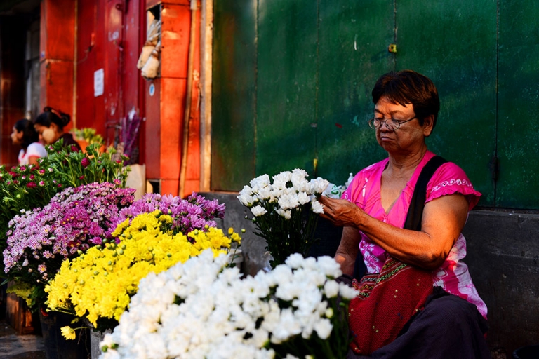 Myamnar Travel Photos of a woman selling flowers in downtown Yangon. - Kira Horvath Photography