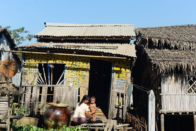 A boy is washed by his mother in front of their modest home in the Dala township of Myanmar. Despite its close proximity to Yangon the township is largely rural and undeveloped. - Kira Horvath Photorgaphy