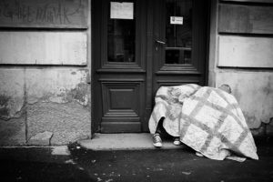 Refugees take shelter under blankets in the streets of Belgrade, Serbia. - Kira Horvath Photography