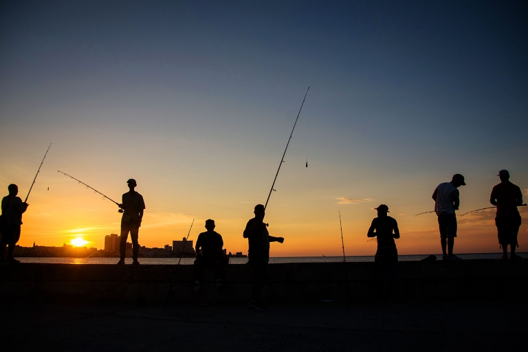 Fishermen at sunset on the Malecon in Havana Cuba. 