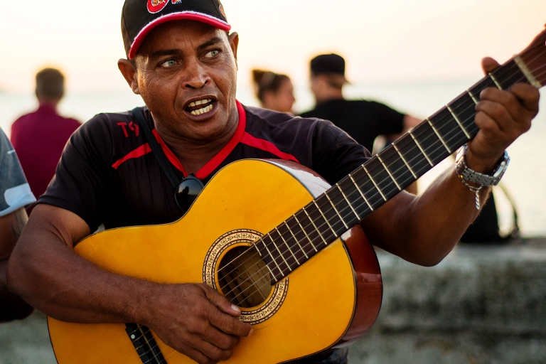 Musician playing on the Malecon in Downtown Havana Cuba travel photography.